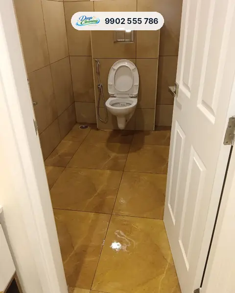 Clean bathroom with glossy marble-look floor tiles and a wall-hung commode