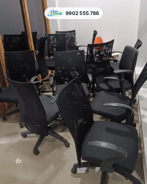 Group of black mesh office chairs gathered in one room