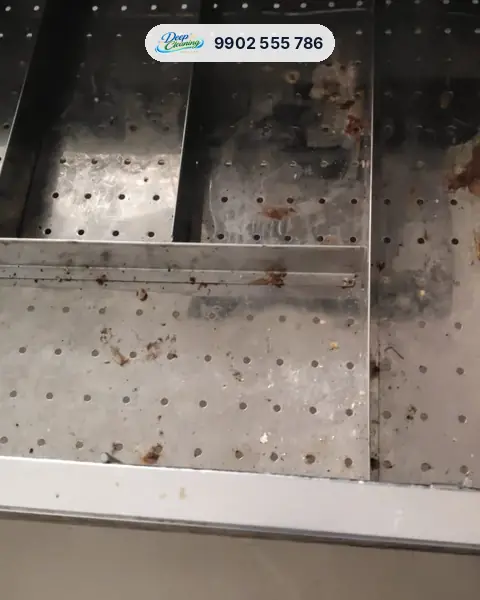 Steel kitchen drawer basket with food stains and rust marks