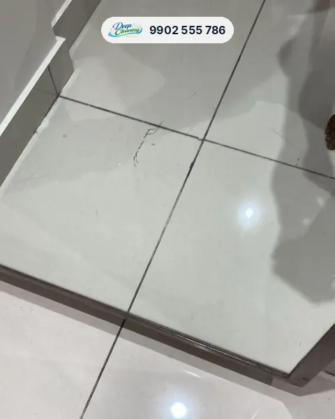 Mirror panel resting on tiles with scratches, dust and paint marks