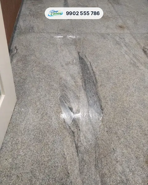 Close view of a new granite floor with dark residue streaks