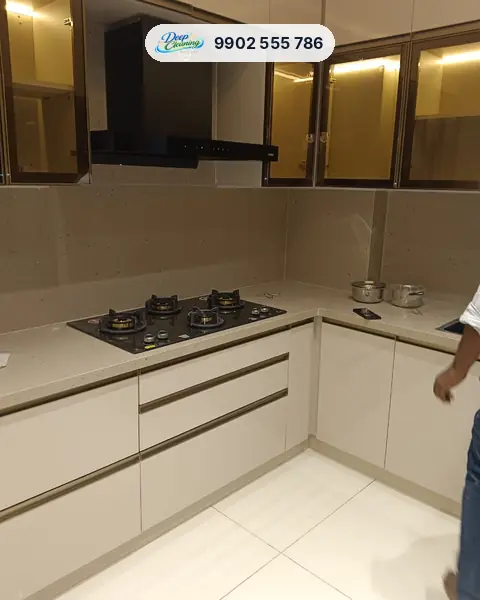 Clean modular kitchen with a glass hob, chimney and lit glass cabinets