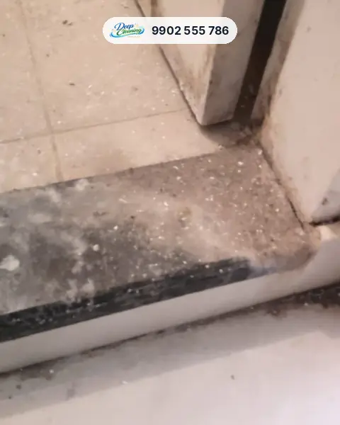 Granite door threshold covered in dust and white paint specks